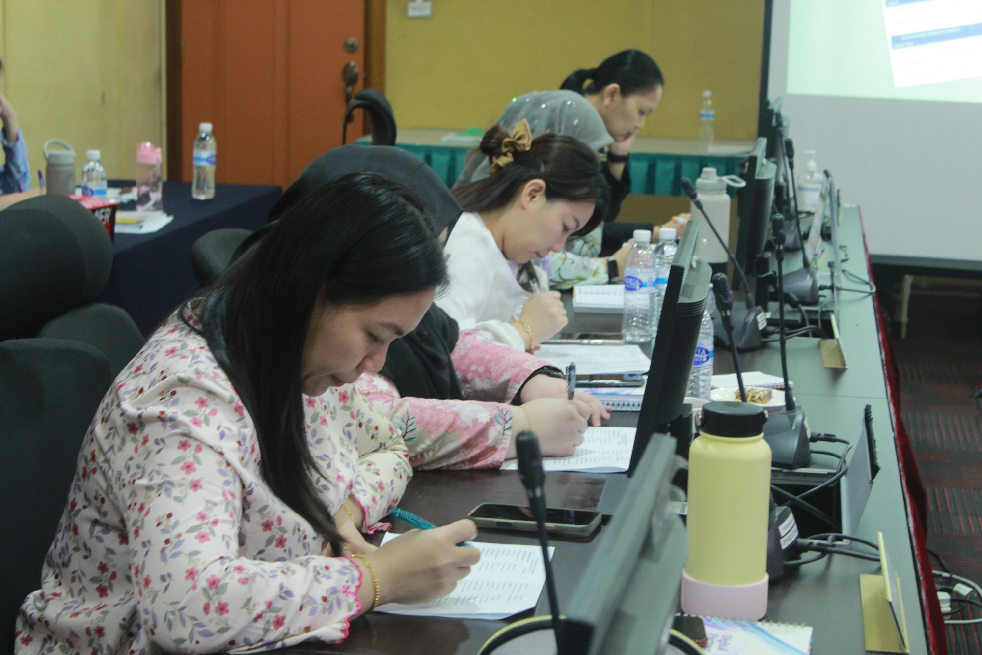 Participants deep in a writing exercise at an E.G Wise course